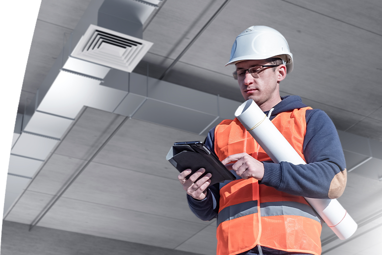 Man engineer. Ventilation system design. Builder guy near air handling unit.